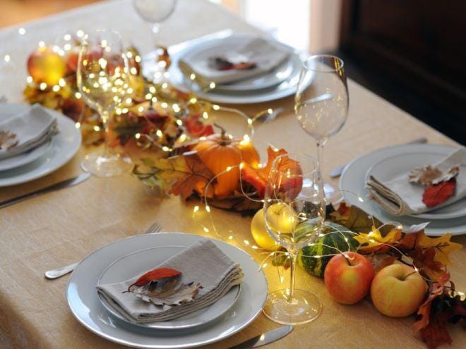 The final image depicts a beautifully laid table setting bathed in soft light featuring simple white plates and golden accents that complement the surrounding autumnal decorations including small pumpkins and leaves ready to host a Thanksgiving feast
