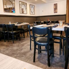 Fully Upholstered Black Metal Commercial Bar Stool with Kidney Shaped Back and Nailhead Trim