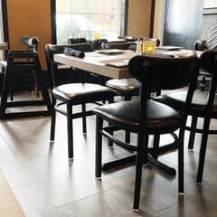 Fully Upholstered Black Metal Commercial Chair with Kidney Shaped Back and Nailhead Trim