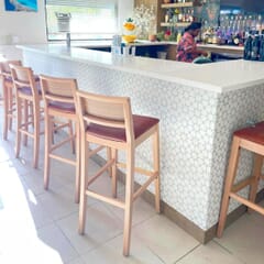 Fully Upholstered Natural Wood Madison Commercial Bar Stool with Nail-head Trim