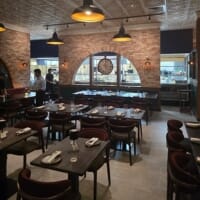 Rustic pewter table tops with black metal bases at Indian restaurant
