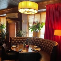 Dining room with cross-back chairs at La Plage Bistro