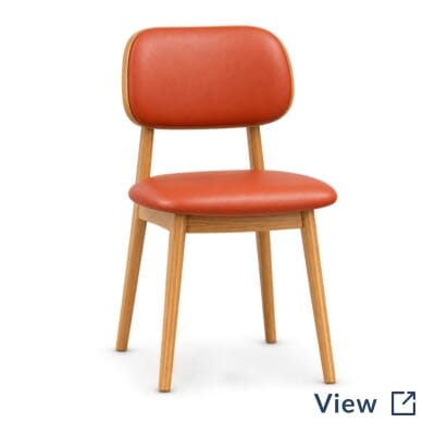 Installation detail of natural-finish Lola café chairs with Symphony Classic Persimmon upholstery.