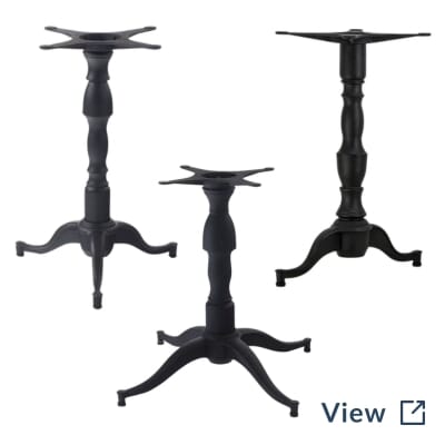 Black cast iron pedestal commercial table bases used in standard and bar-height configurations at The Belmont.