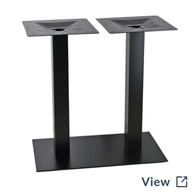 Black commercial metal restaurant table base used beneath walnut oak dining tables at St. Joseph by-the-Sea High School.