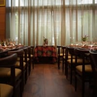 MARCUS DC bar area showcasing natural wood bar stools with Canyon Pumpkin upholstered seats.