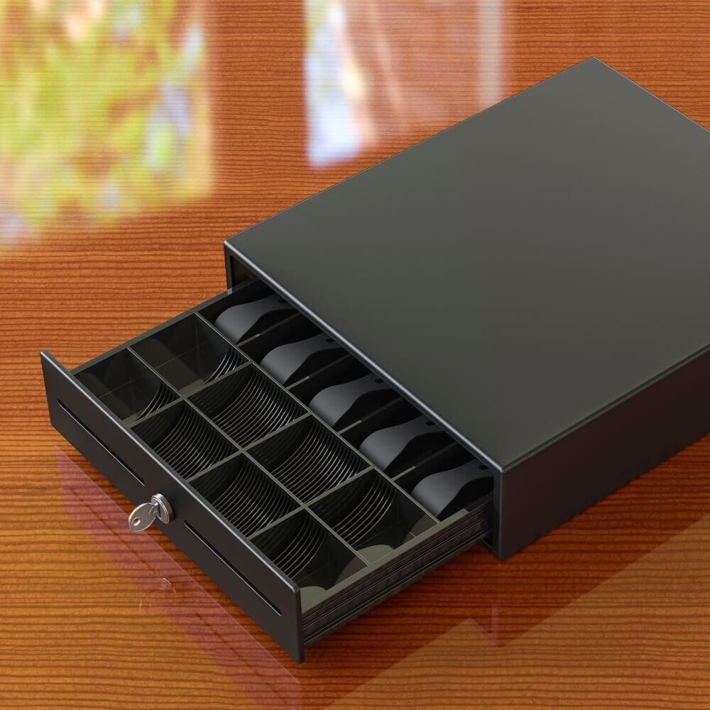 Black cash drawer with open compartments for bills and coins on a restaurant counter