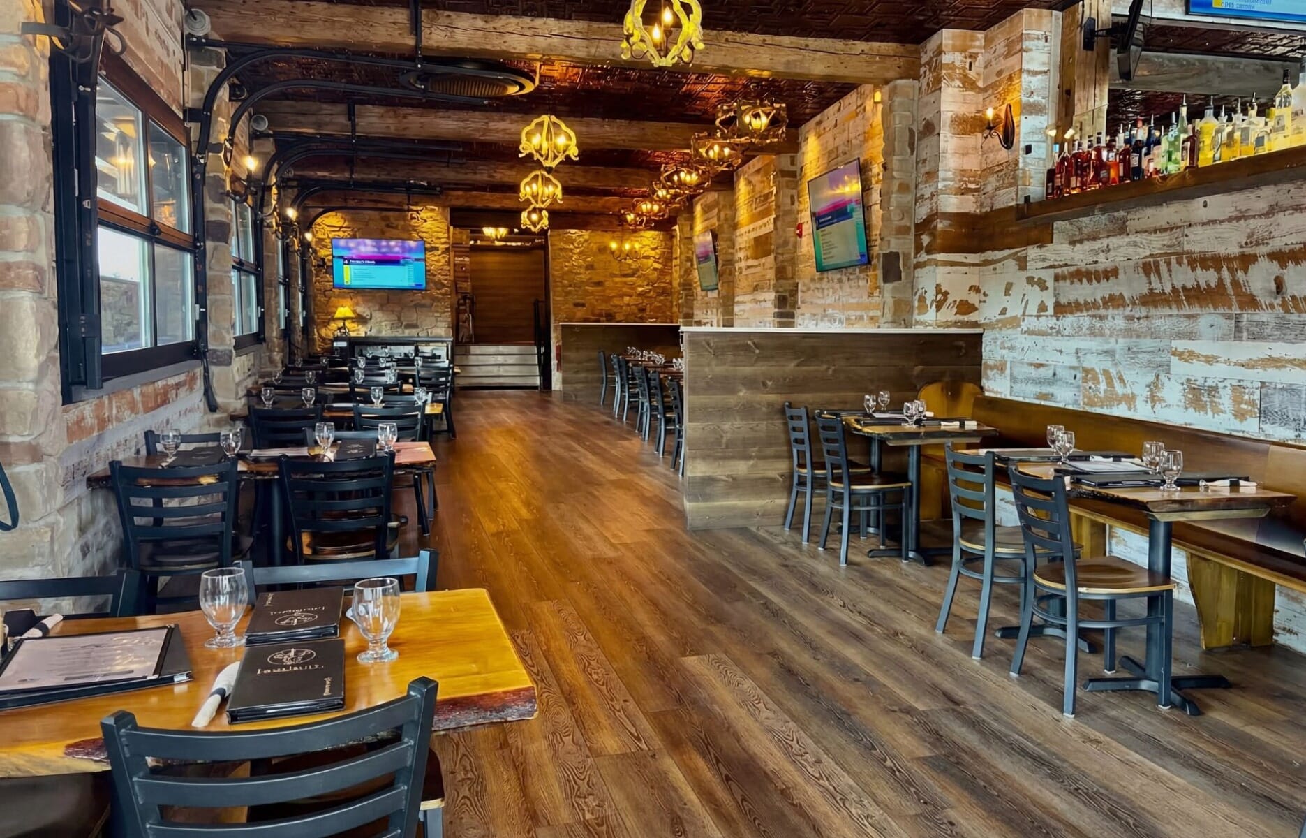 Exterior of Dog and Bull Taphouse and Kitchen in Croydon Pennsylvania featuring classic English pub facade with blue signage at the renovated Croydon train station