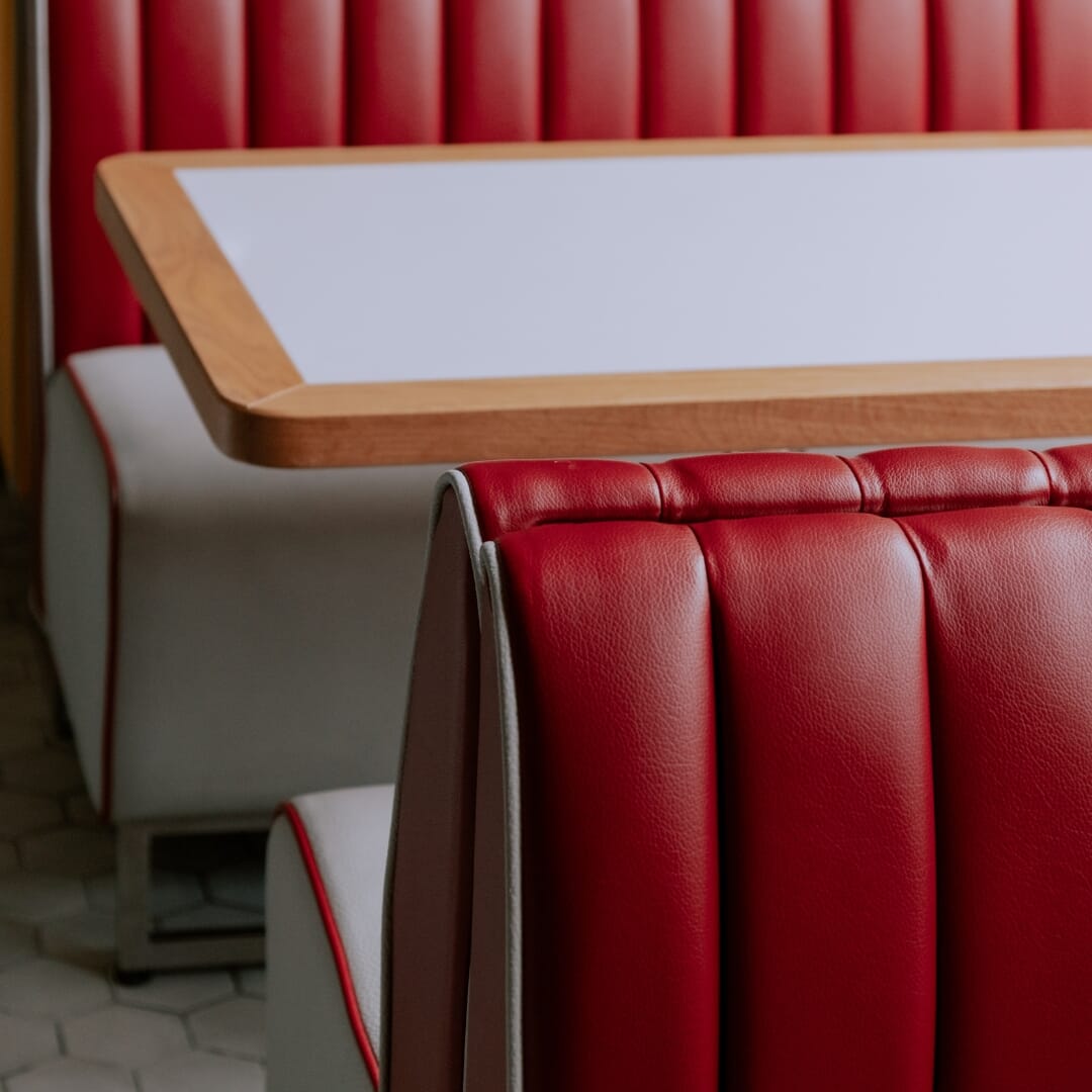 Close-up of patterned cushion and wood tabletop used in a Mexican-style dining space