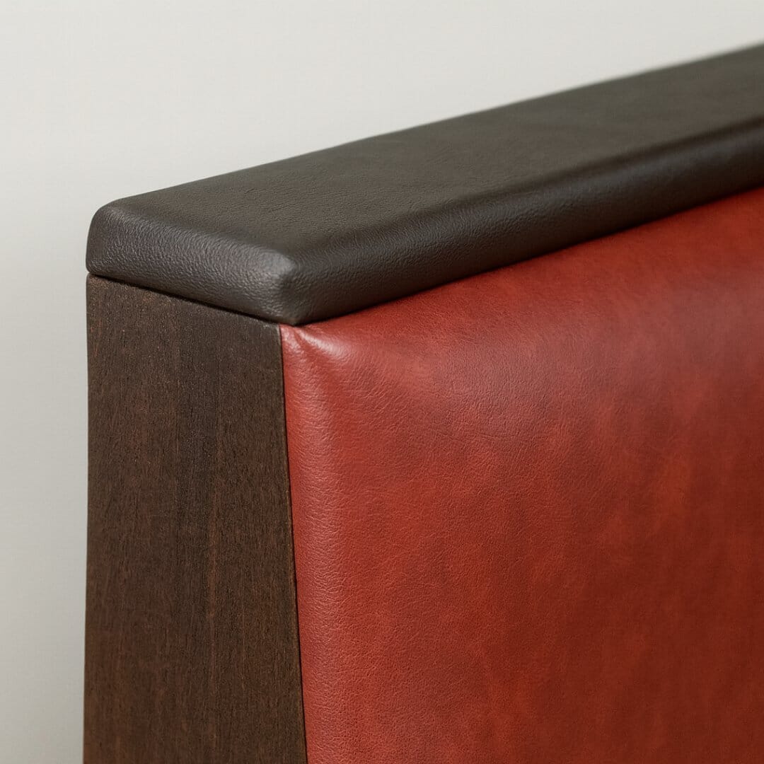 Upholstered booth top cap for a softer, cushioned finish