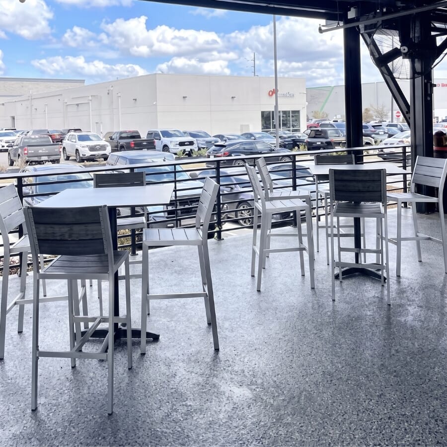 PopStroke Katy commercial sports bar and mini golf furniture showing aluminum tables, synthetic teak outdoor seating, and flexible dining configurations.