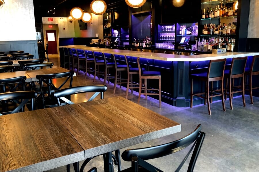 Five 13 Liquor Lounge in Franklin Lakes New Jersey featuring walnut restaurant bar stools, black steel seating, Zebrano tables, blue accent lighting, and a modern cocktail bar.