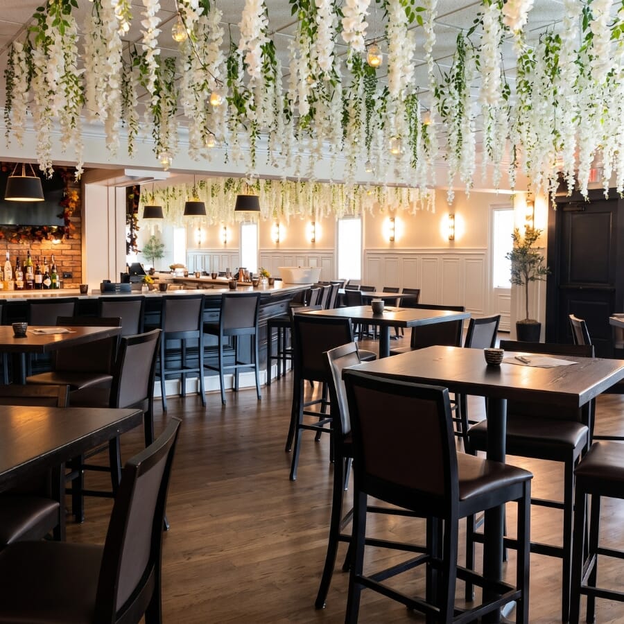 Branches Catering banquet and wedding reception space with black solid oak commercial tables, upholstered Morgan dining chairs, and flexible event seating in West Long Branch New Jersey.