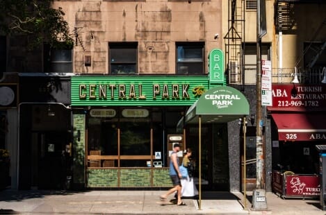 Central Park Tavern NYC - Walnut Tables, Brass Accents & Upholstered Bar Stools Furniture Case Study