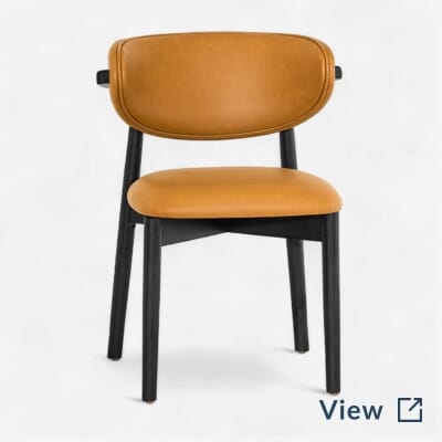 Ruby modern black finish wood restaurant chair with upholstered seat, part of Central Park Tavern NYC’s dining room furniture package.