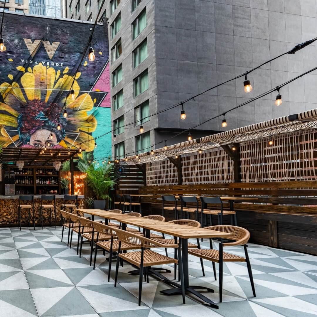 Street-level outdoor dining setup at Vida Verde with colorful seating