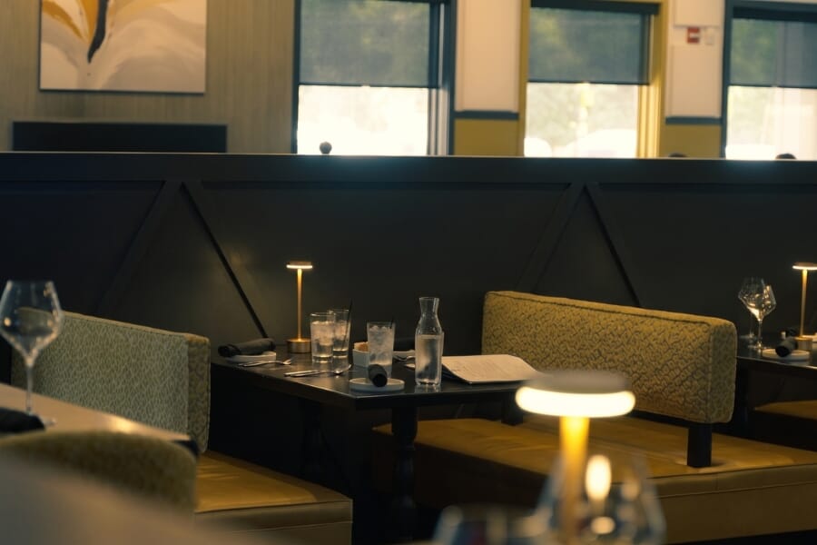 Italian Chophouse on Lake Oconee furniture moodboard featuring black wood, charcoal upholstery, citrine and Dijon accents, warm neutrals, wine tones, and custom restaurant seating.