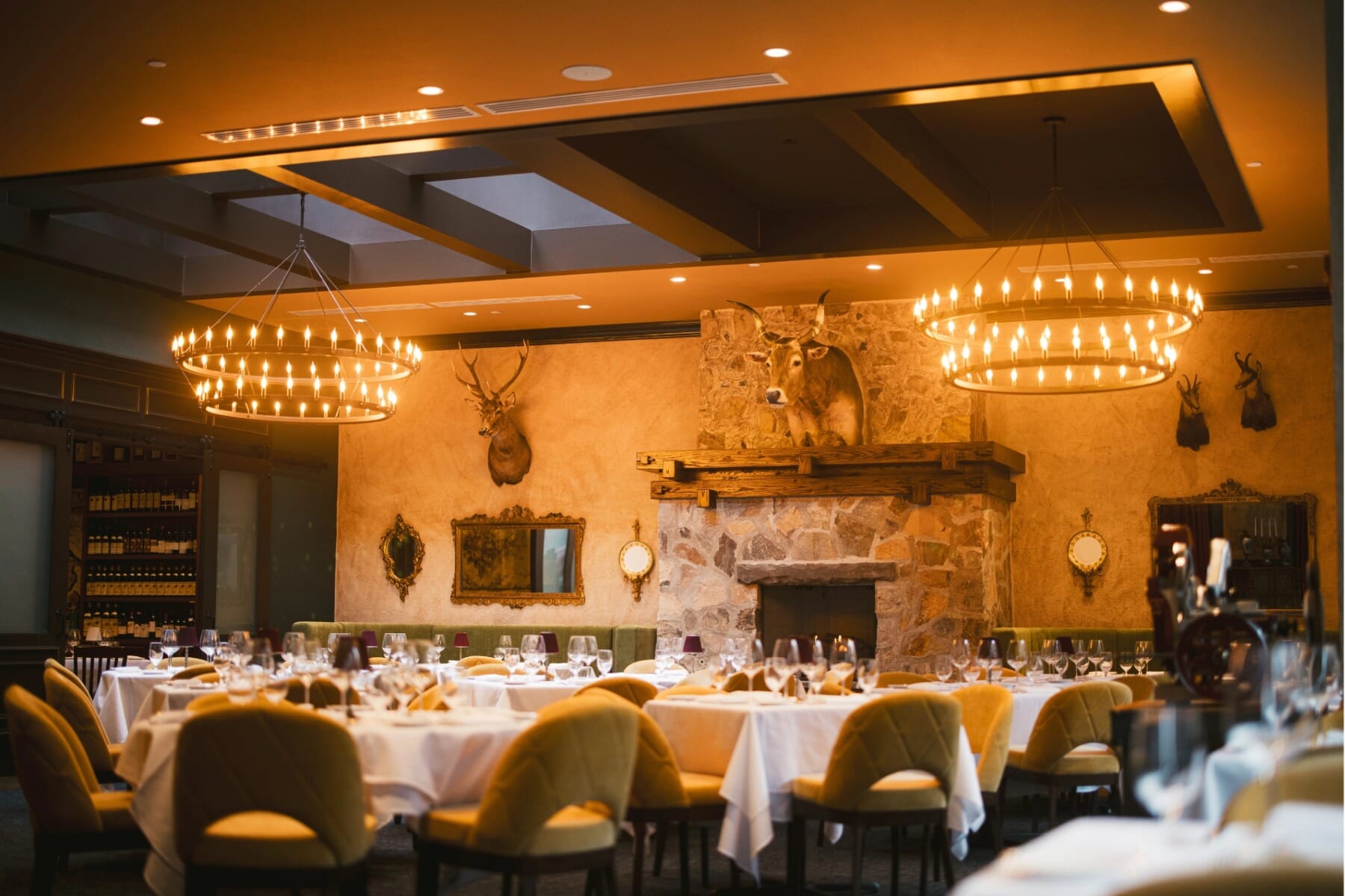 Elegant dining room at Masseria Morristown featuring upholstered chairs, walnut tables, and warm ambient lighting.